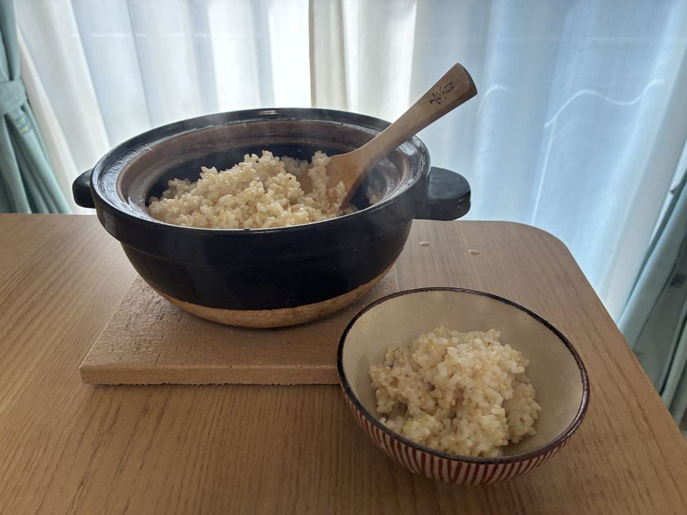 かまどさんで炊いた玄米をしゃもじでよそい、茶碗に盛ったところ